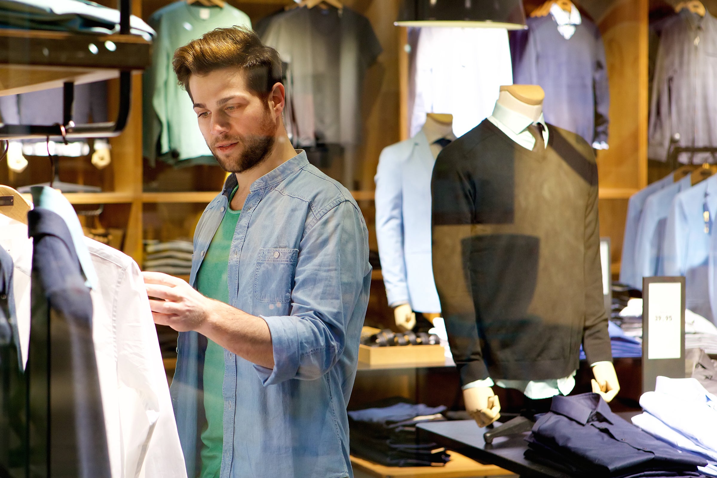 A man browses different articles of clothing.