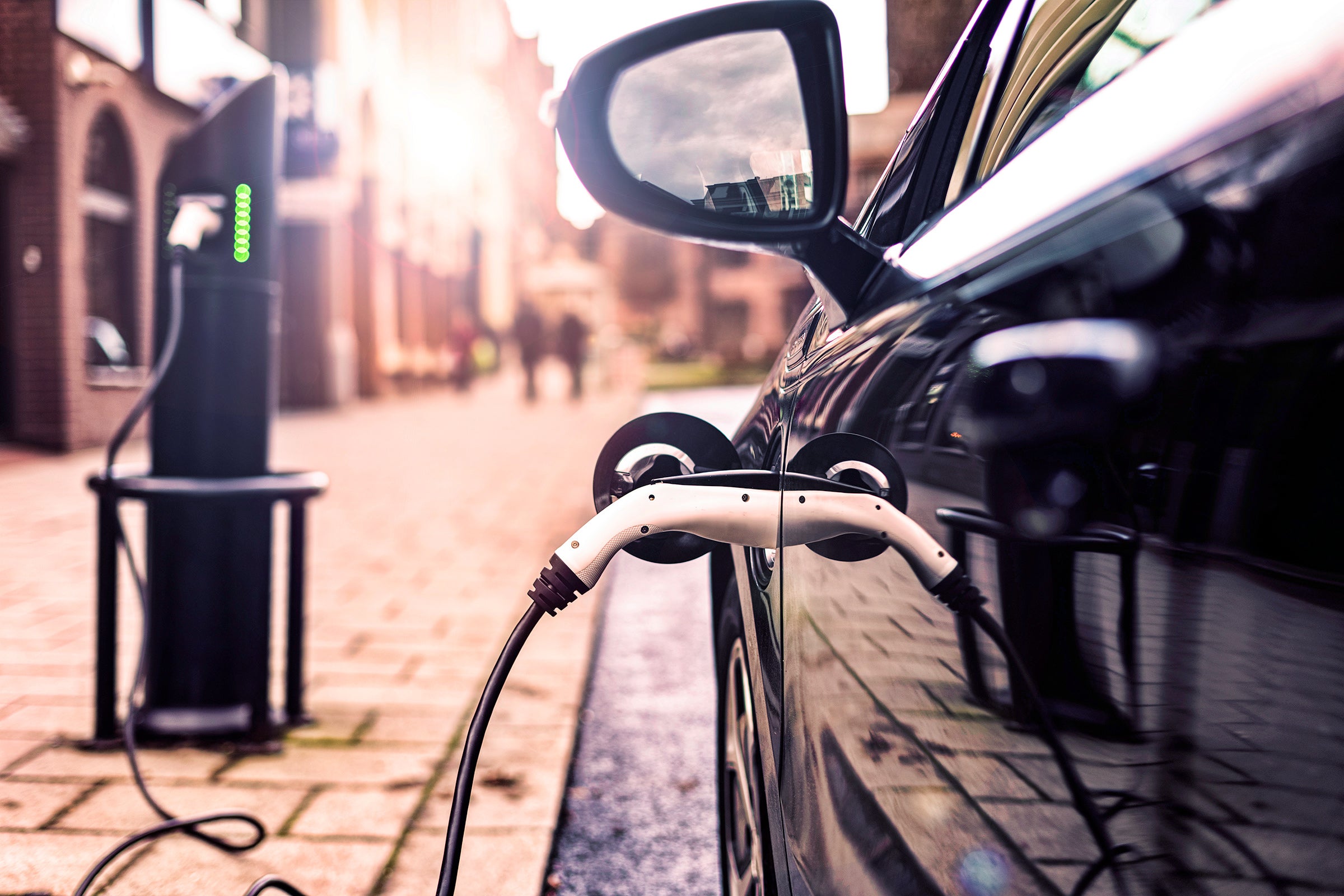 Electric vehicle charging cable plugged into an electric vehicle port