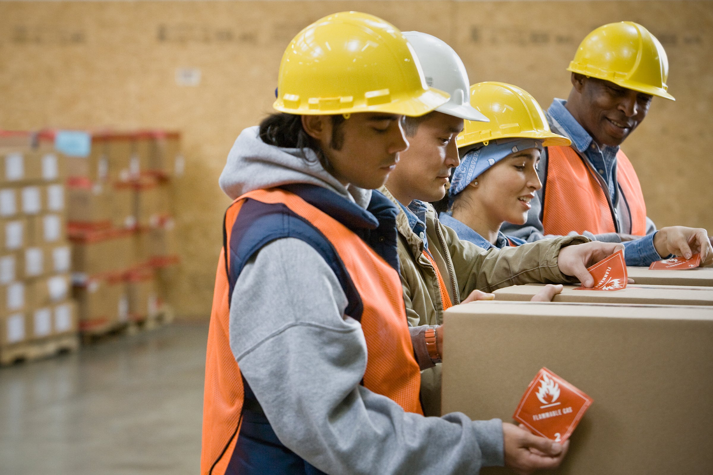 Manufacturing workers applying labels