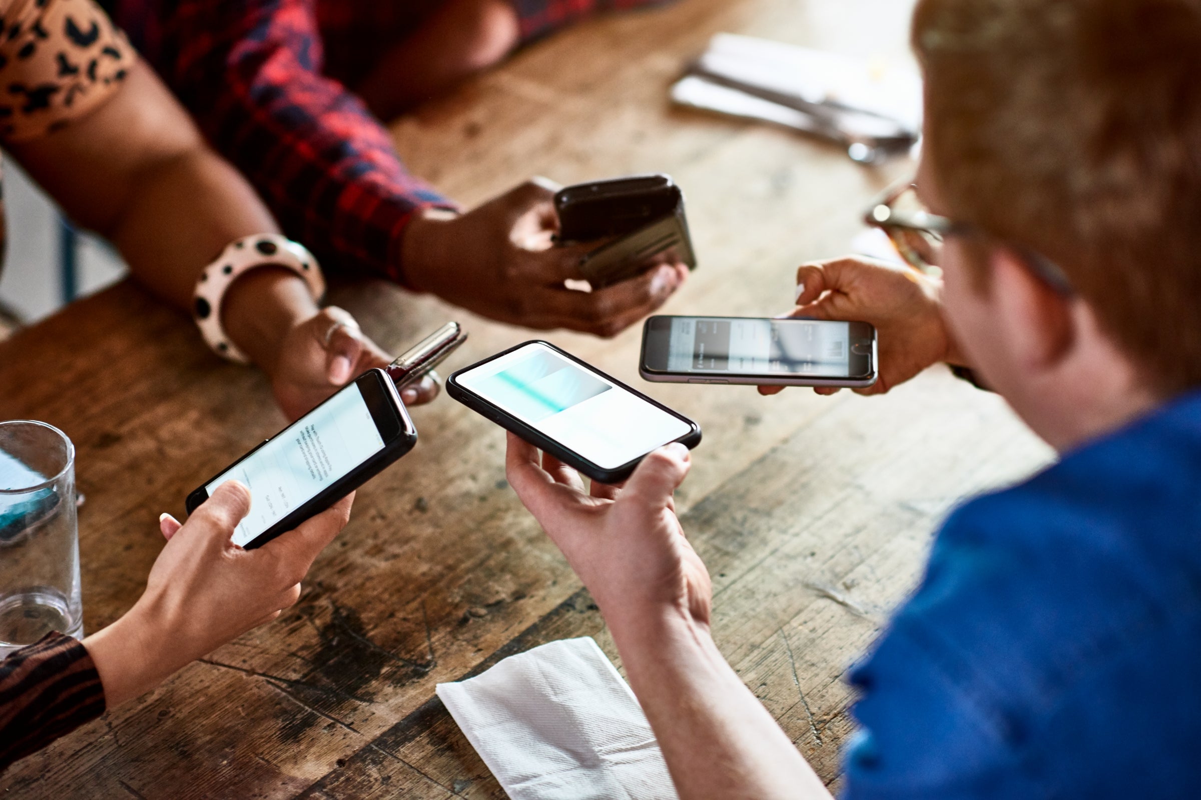 Friends sharing information on smartphones
