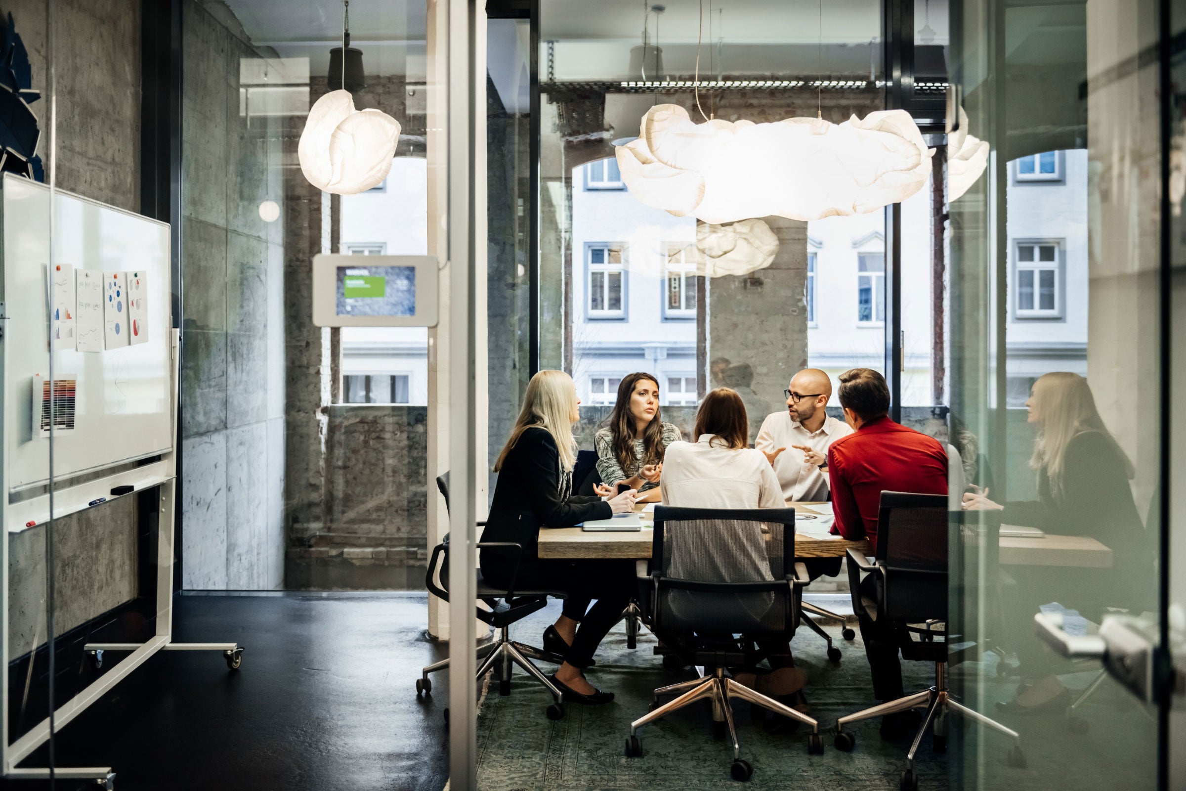 Several people talking around a meeting table