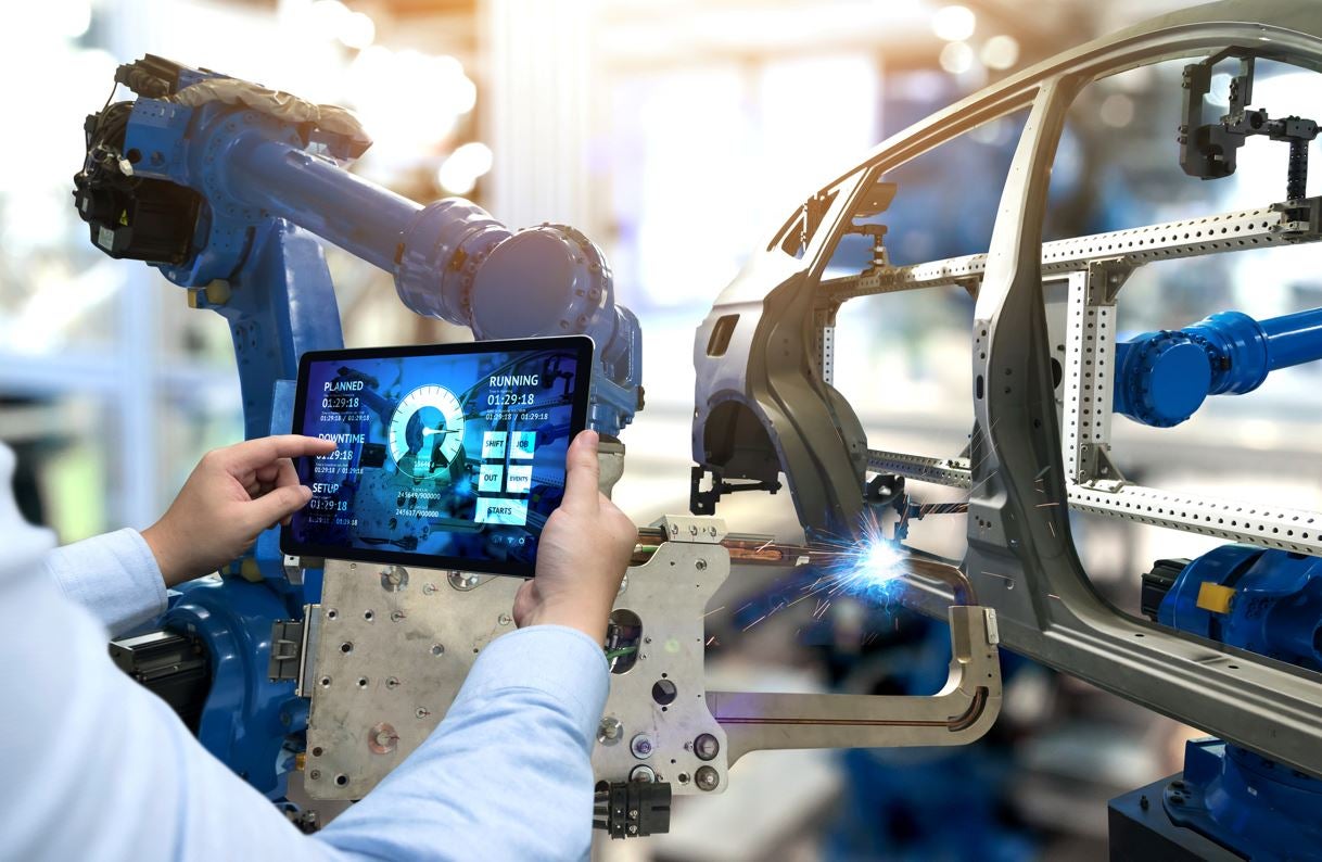 Main holding tablet in front of automated assembly line