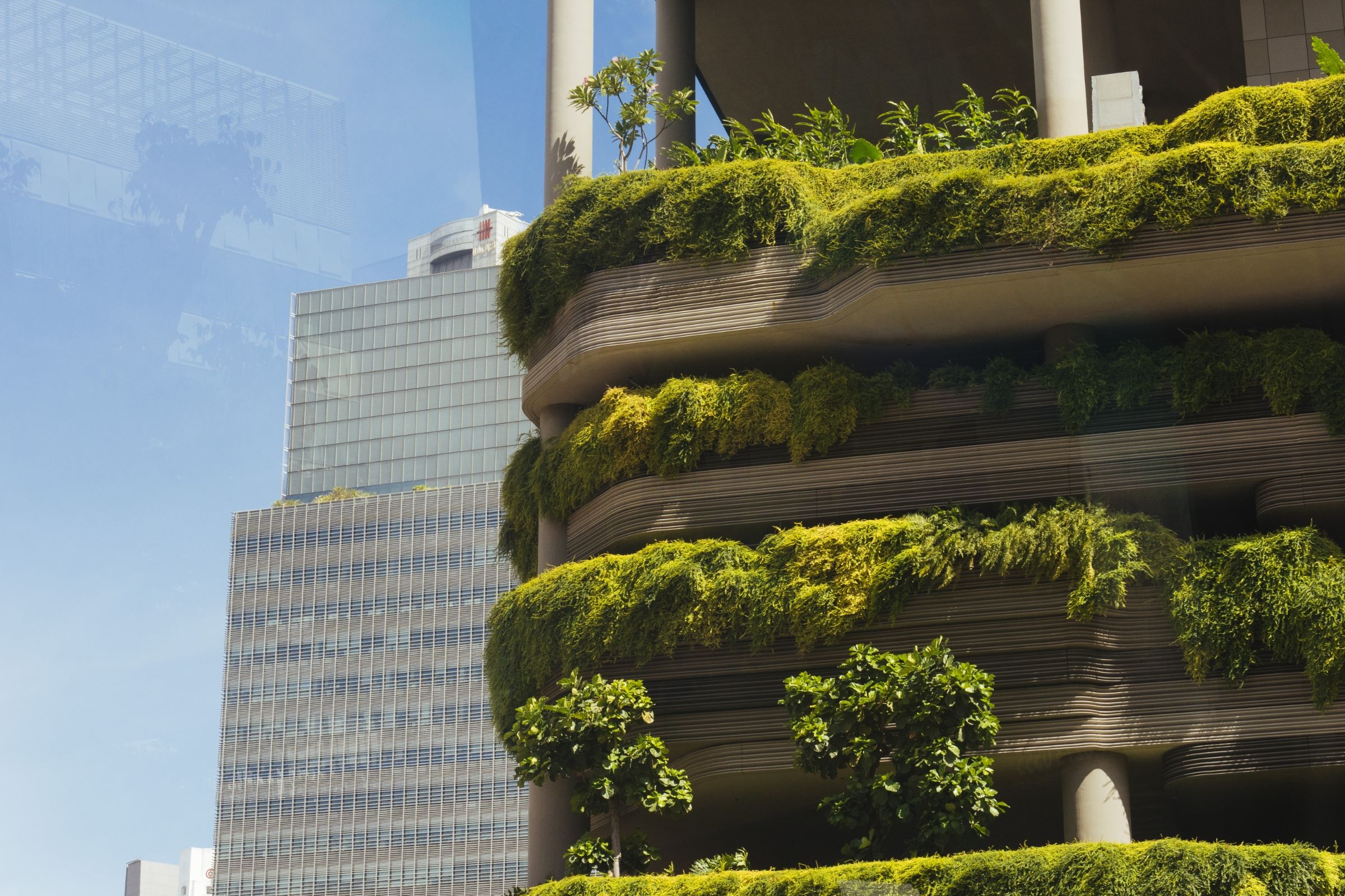 Urban high-rise apartment building with lush vertical garden.