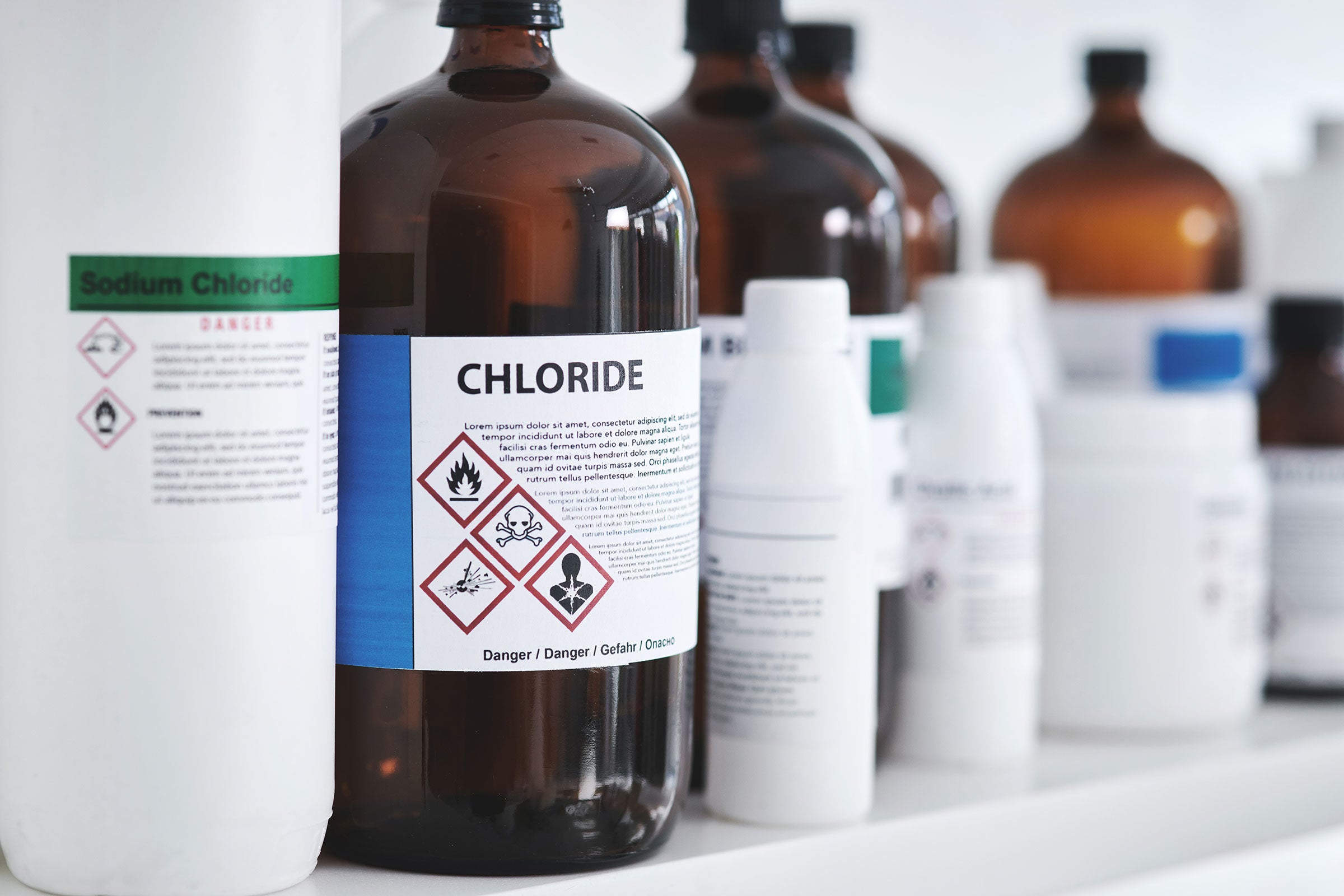 common lab chemicals - bottles of chemicals on a shelf in a lab