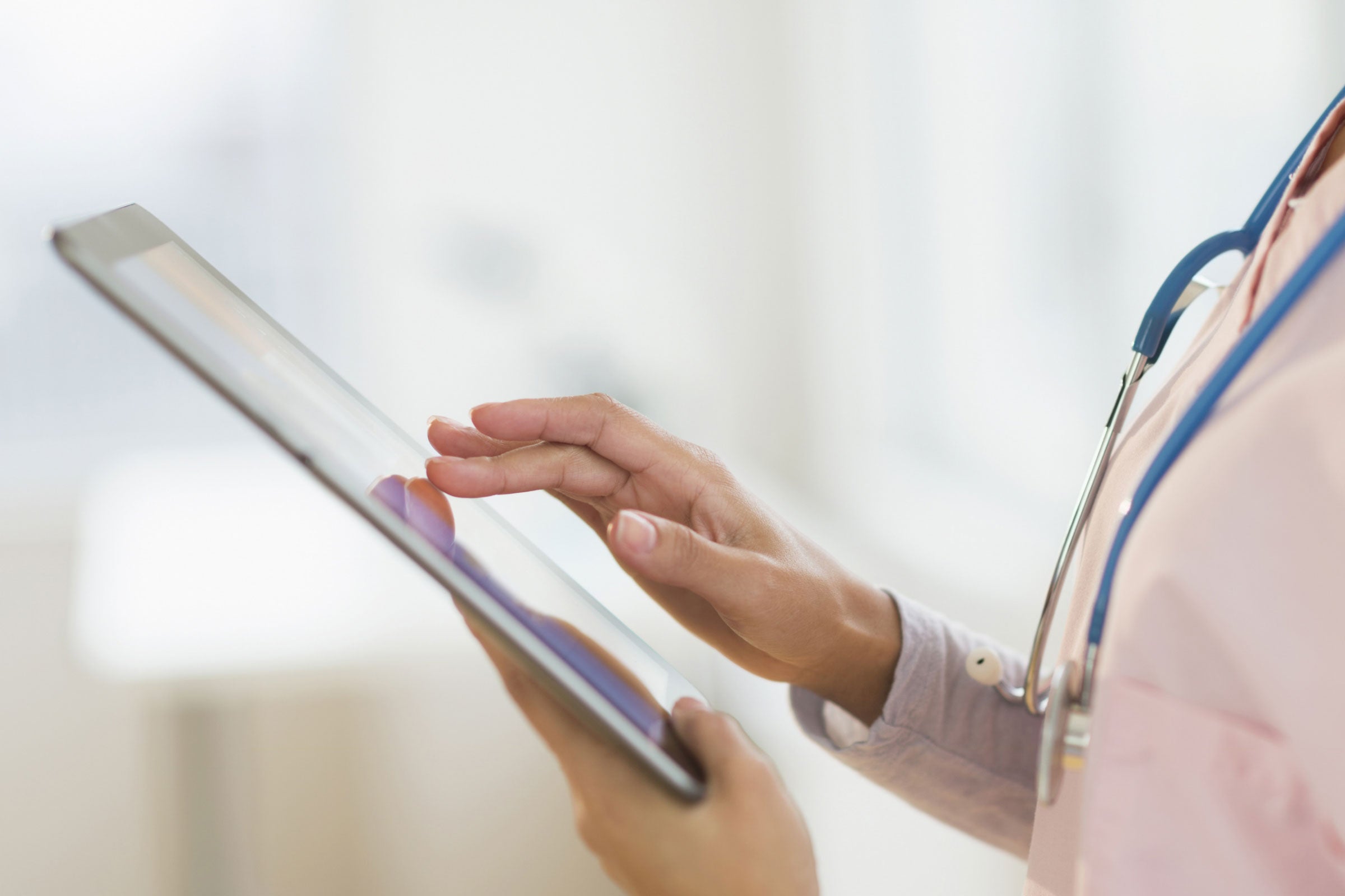 A doctor using a tablet