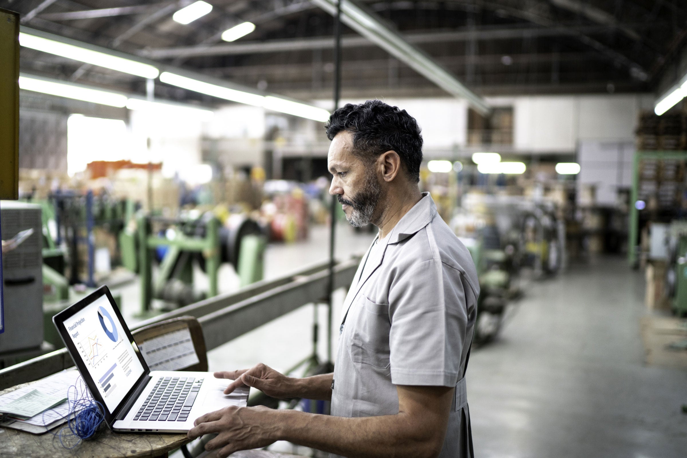  Person using laptop in a factory shop