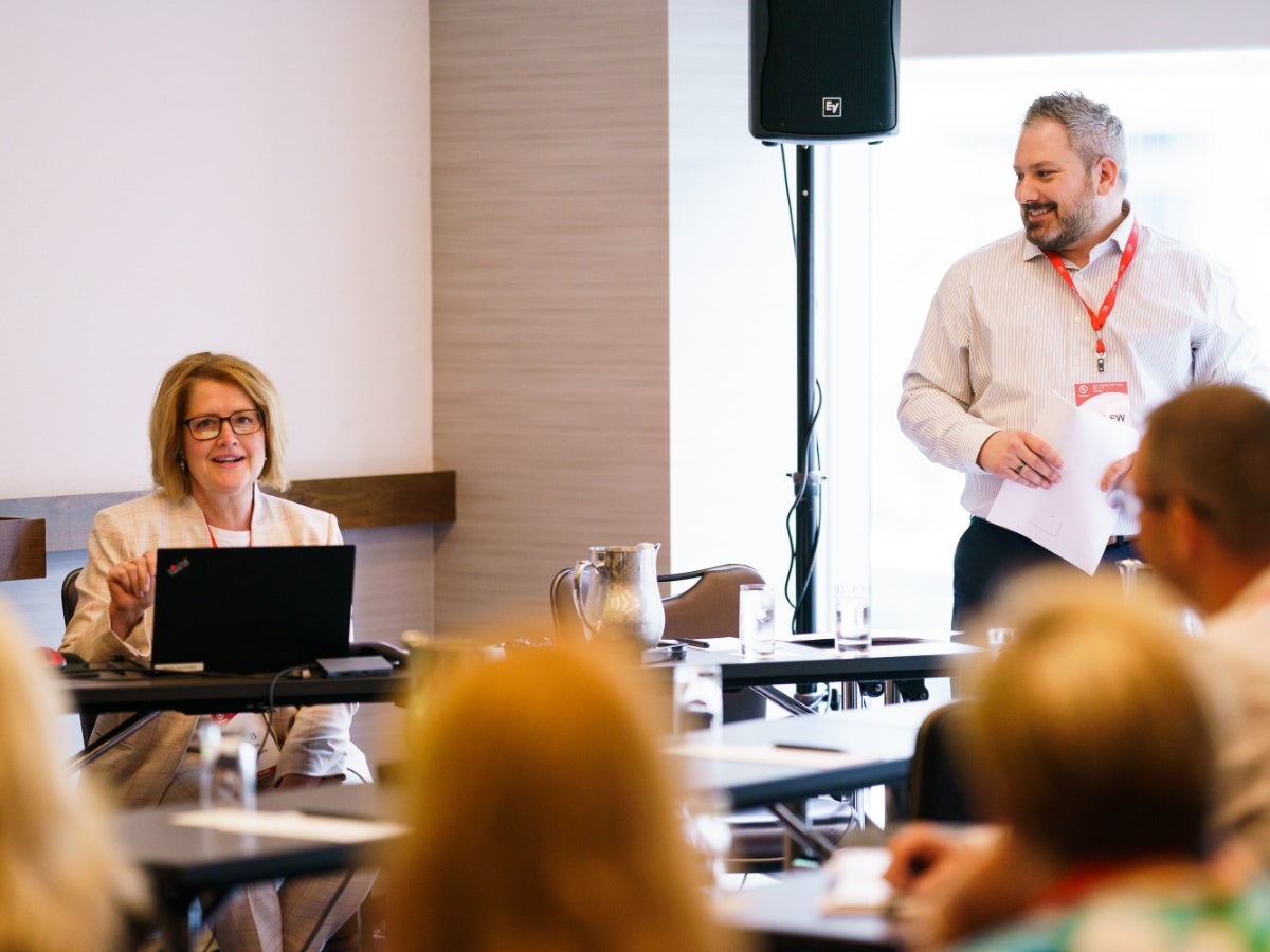 Two UL Solutions employees giving a presentation in a small breakout session