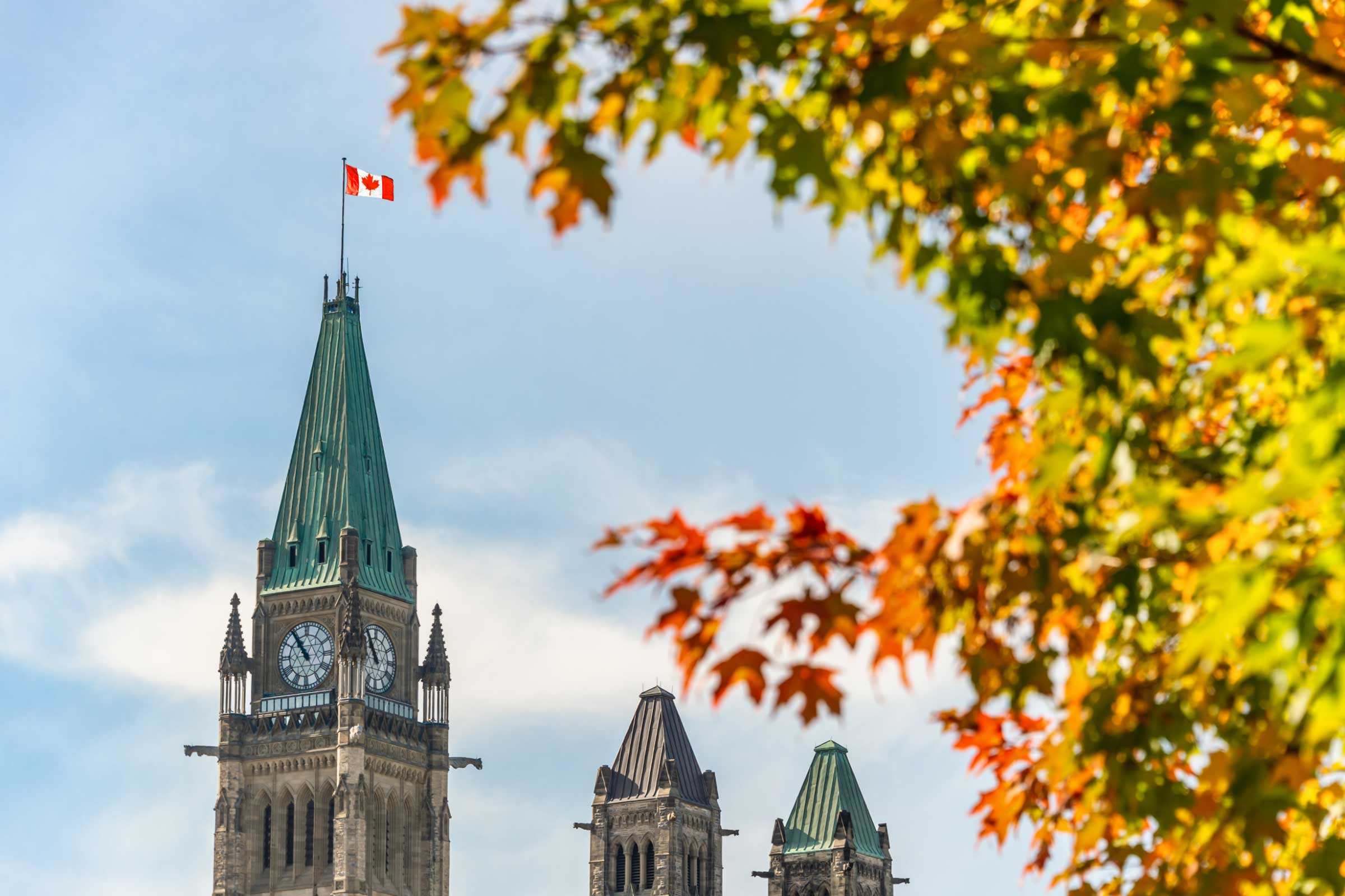 Peace Tower of the Canadian Parliament with autumn foliage in Ottawa