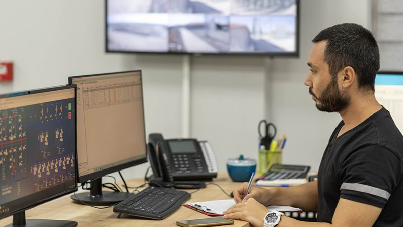 Power plant control room operator working at his desk