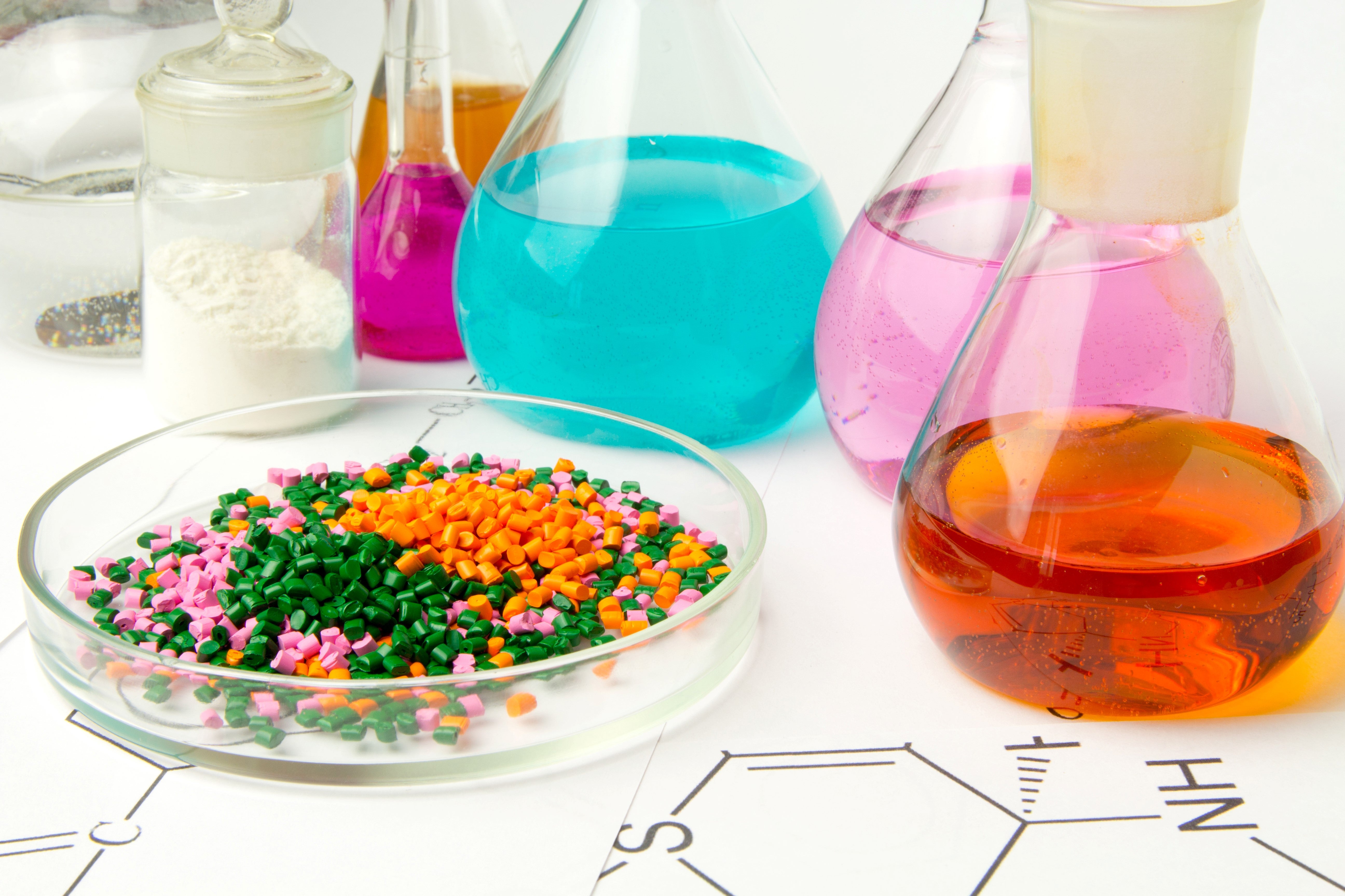 Plastic raw material in granules against the background of Chemical Laboratory and reagents. Polypropylene, Ethylene, Polypropylene research in laboratory conditions