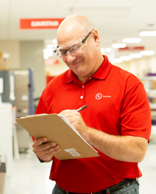 UL Solutions employee making notes on a clipboard