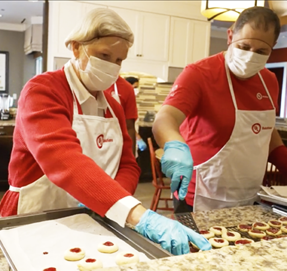 Two UL Solutions employees baking cookies for RMHC