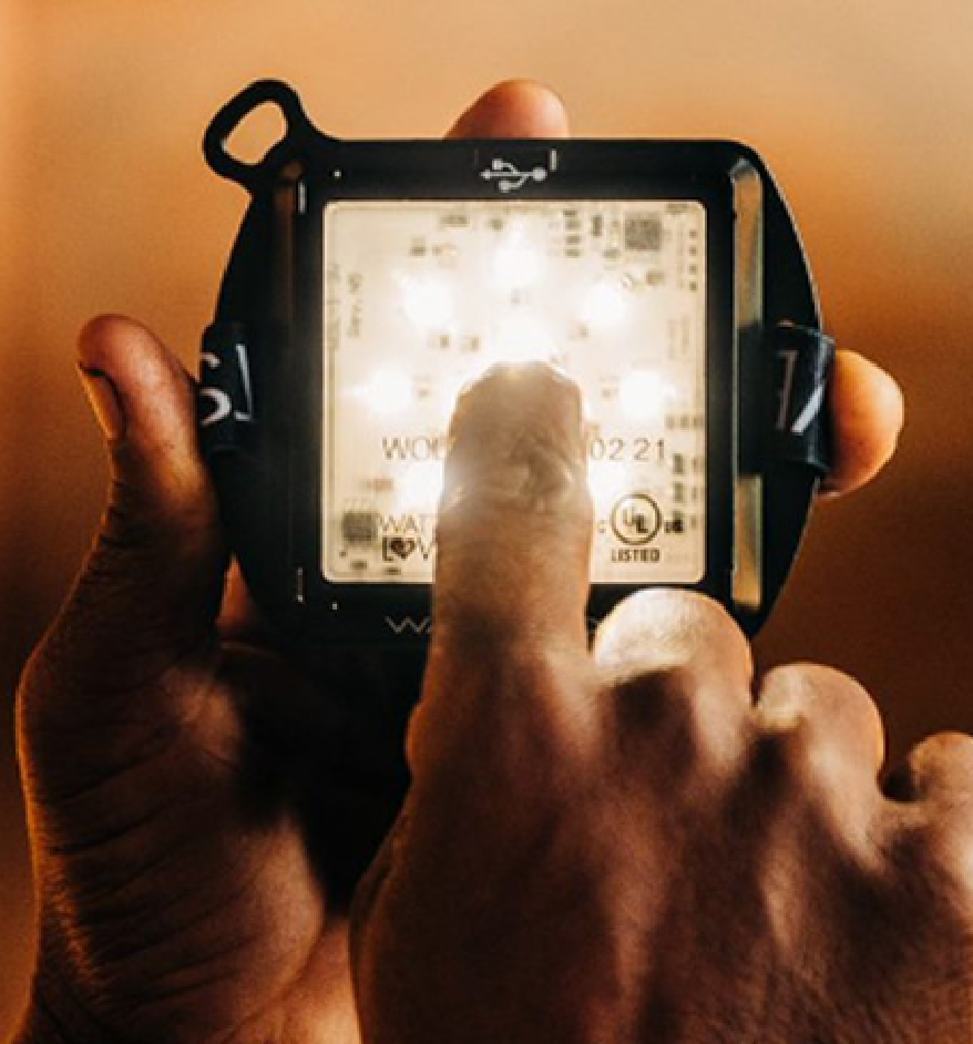 Closeup of a hand holding an illuminated led device