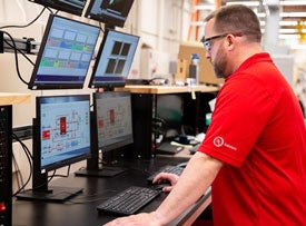 UL Solutions employee working on a computer with several monitors