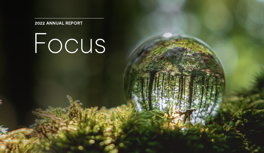 2022 Annual Report - Focus with a closeup view of a water drop in the woods