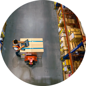 Aerial view of factory worker between rows of shelves