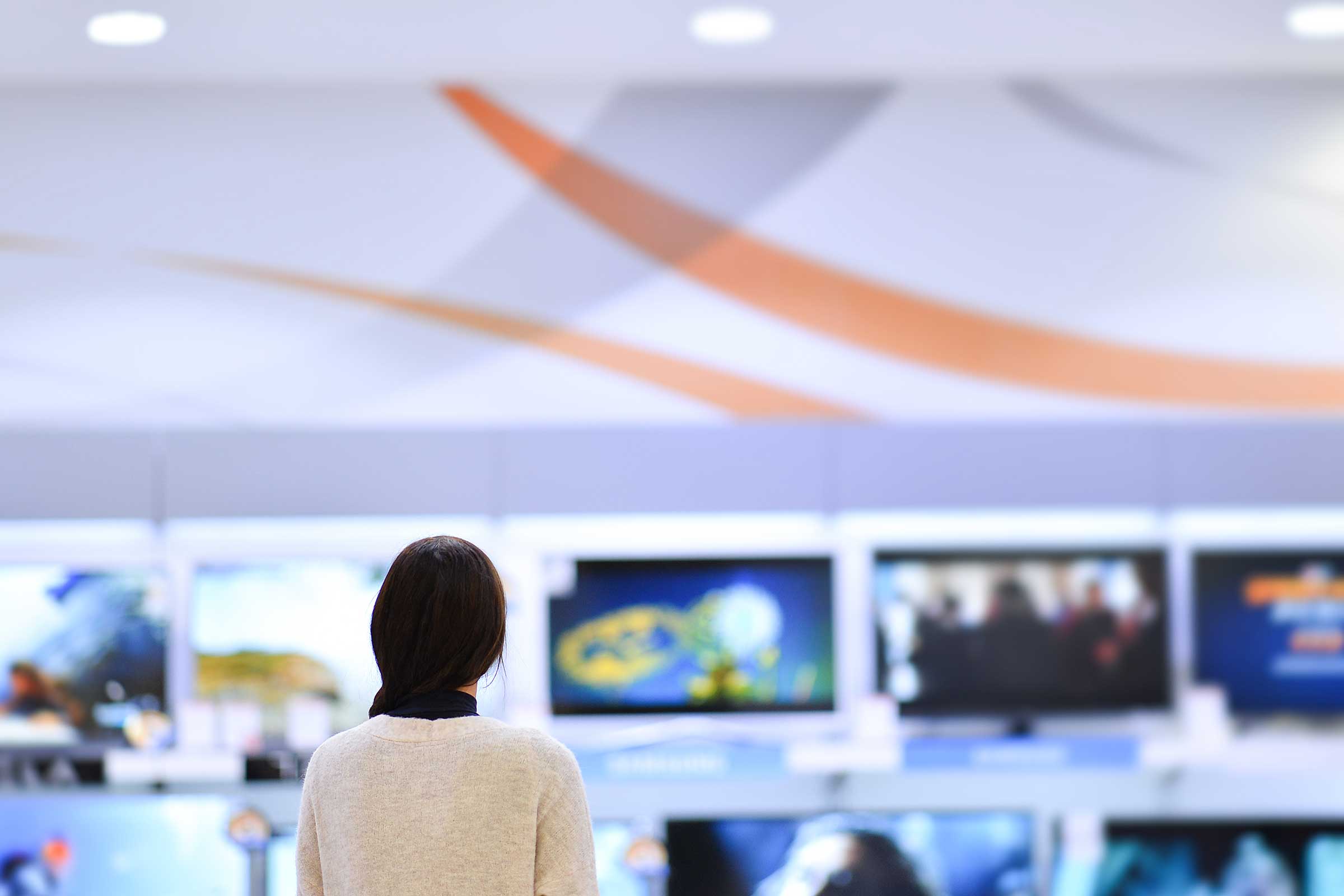 Person looking at televisions in a store