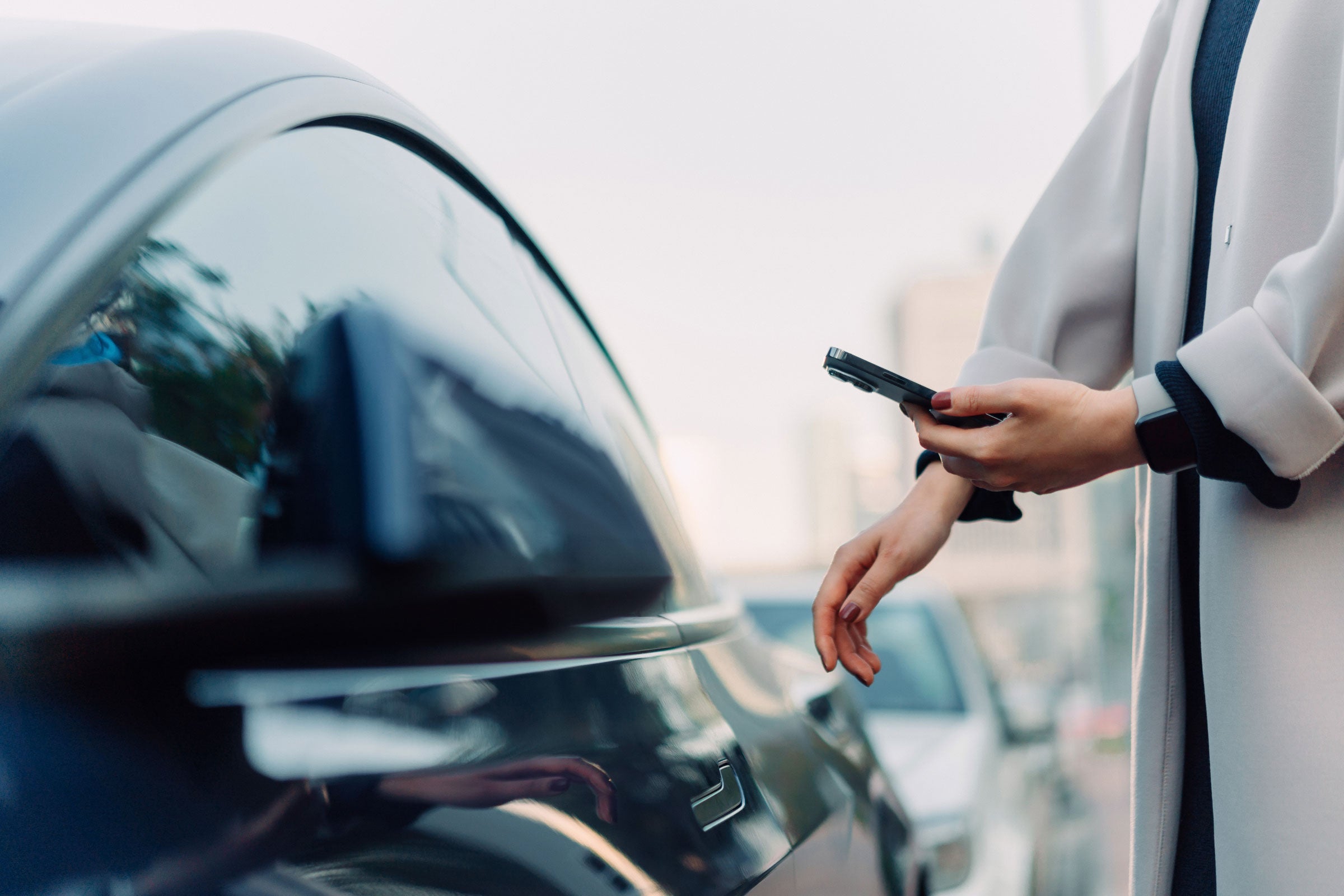 A person looking at an app for their smart vehicle