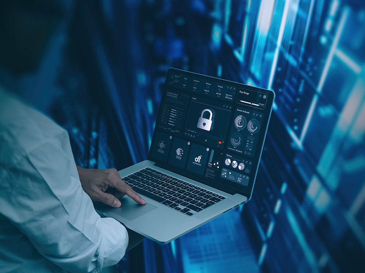Person using a laptop to make sure their system is secure
