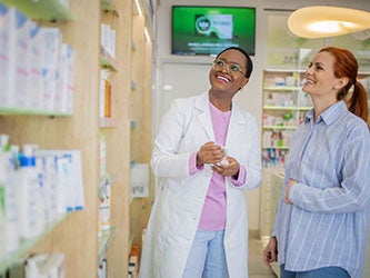 A satisfied customer talking to a pharmacist