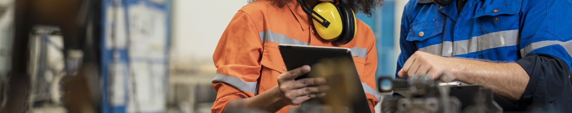 Two colleagues working together on a tablet