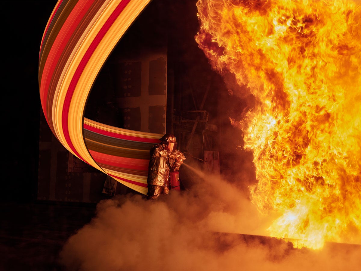 A laboratory technician tests fire extinguishers to determine if they meet safety standards.