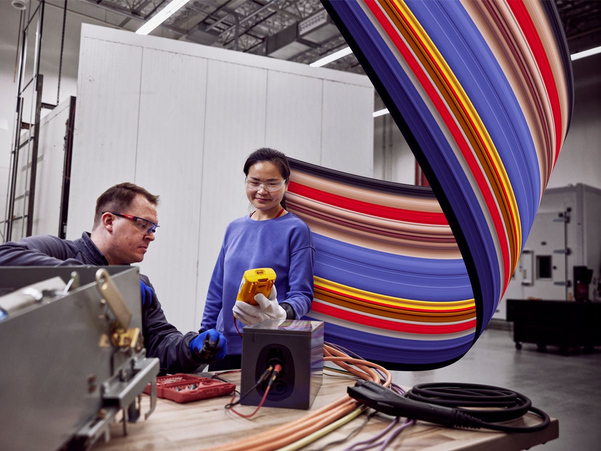 Employees collaborating at UL Solutions Electric Vehicle Laboratory.