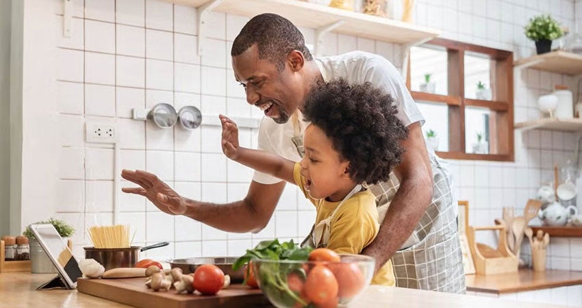 Parent and child cooking together