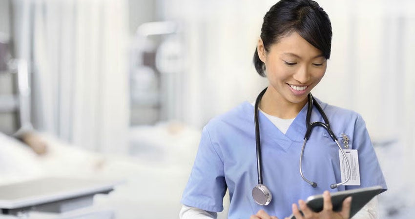 A nurse working on a tablet