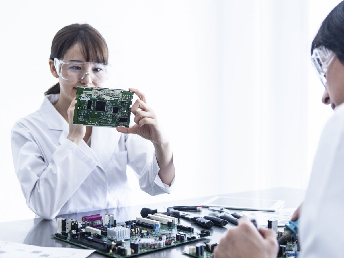 Researcher looking closely an electronic board