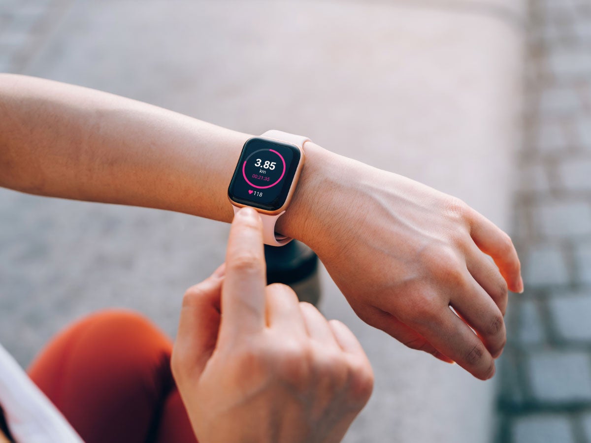 Person checking fitness statistics on smartwatch