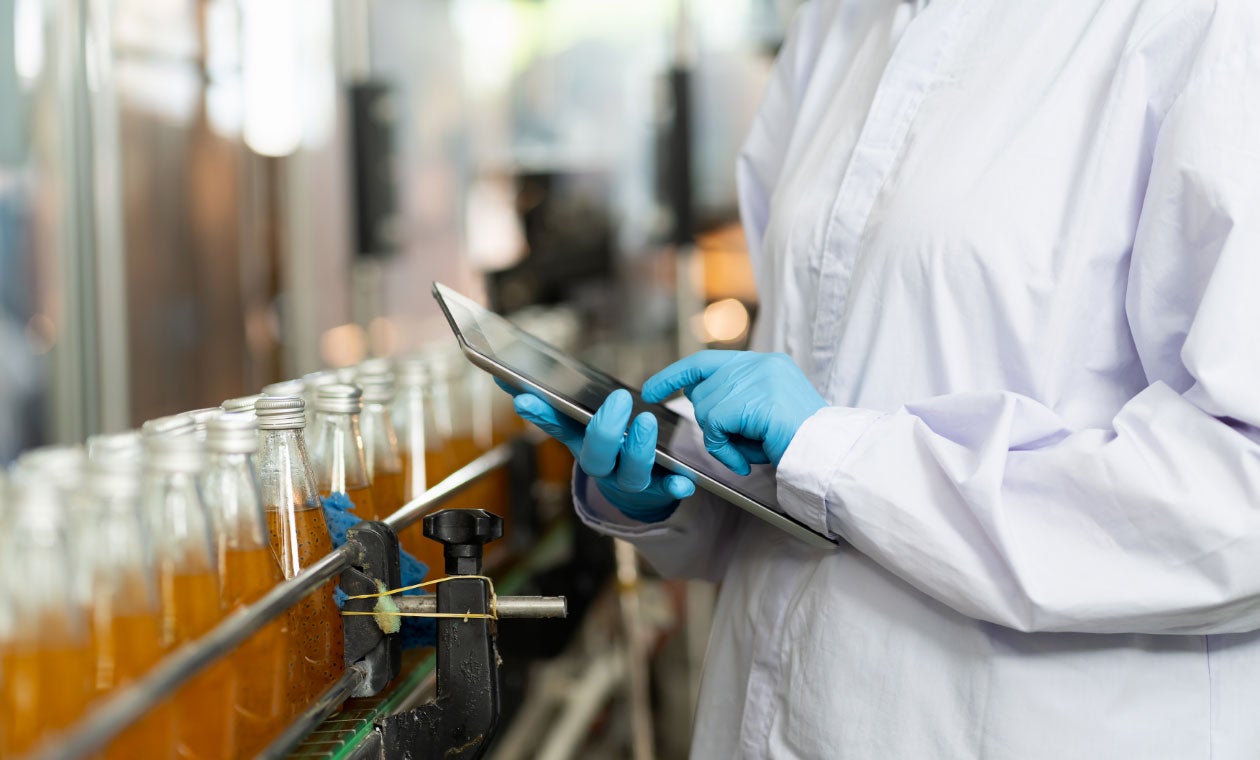 Quality control worker analyzing products on a production line