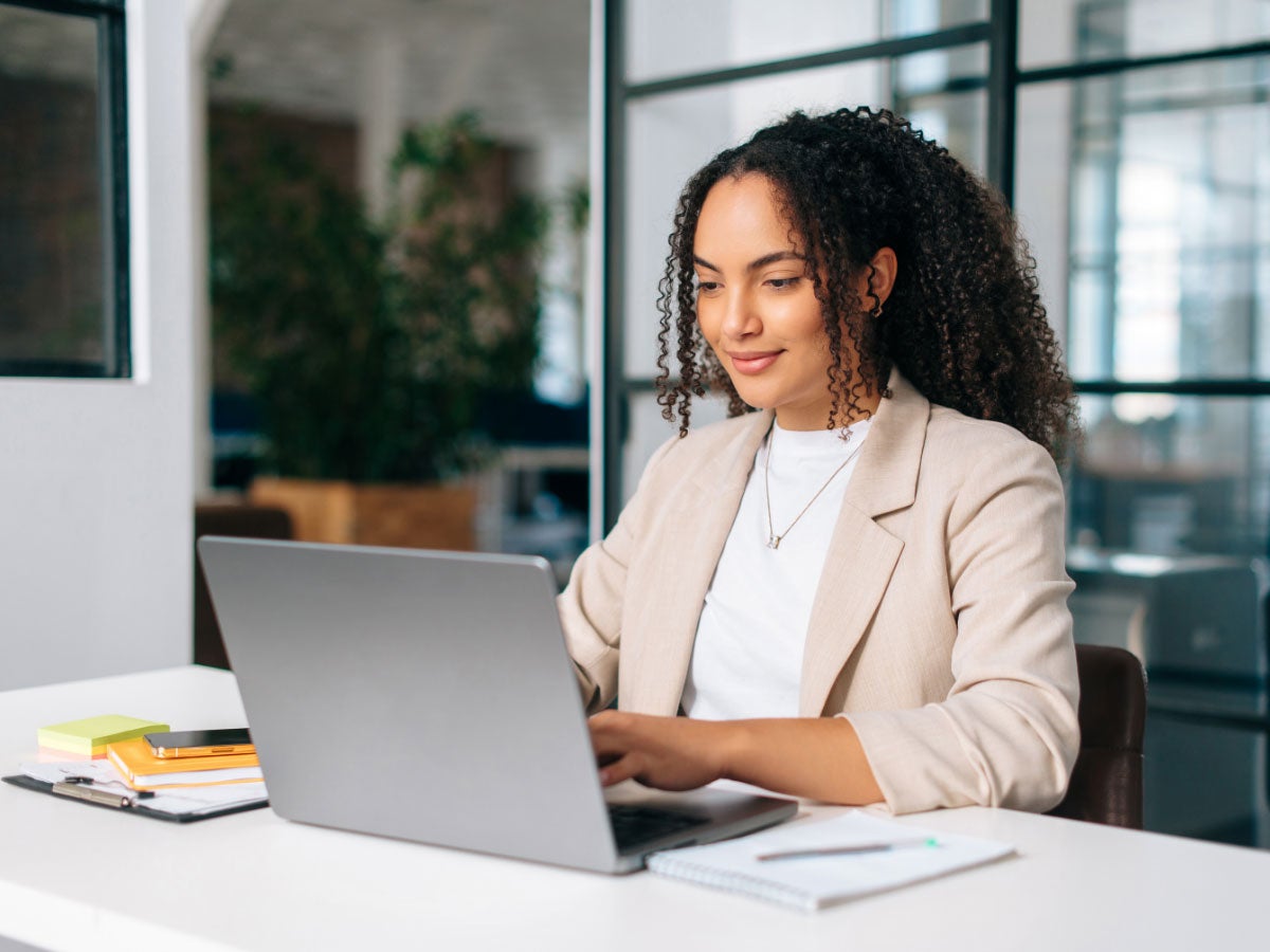Office employee using a laptop while sitting in the office
