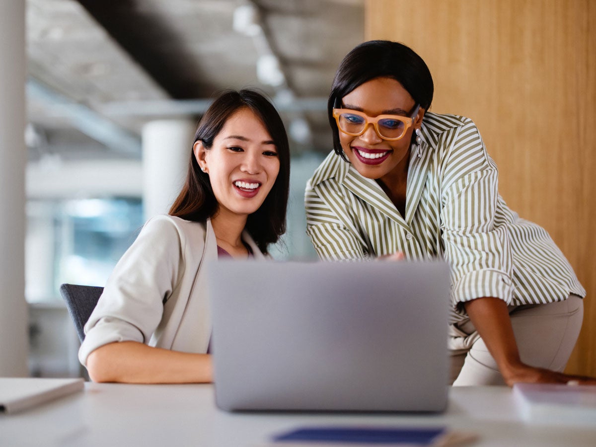 Two business colleagues collaborating over a laptop