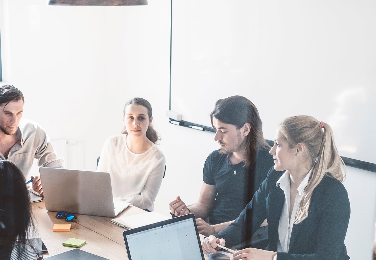 A group of people around a conference table