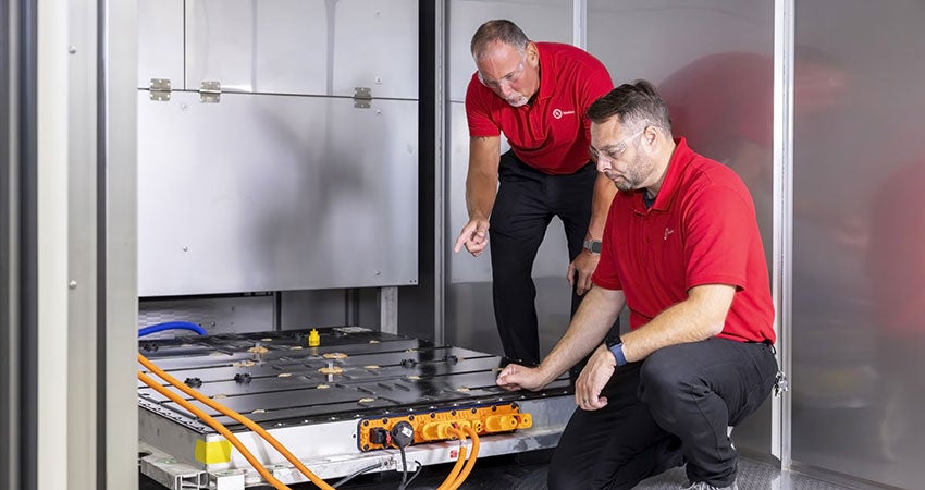 Two UL Solutions employees testing an EV battery
