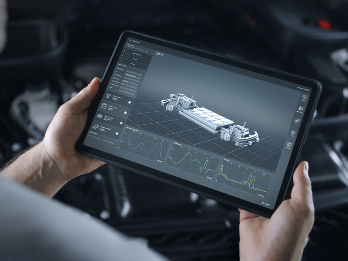 A person looking at an EV battery on a tablet