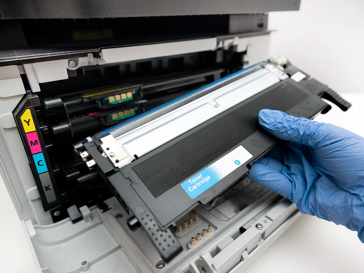Person changing a toner cartridge on a laser printer