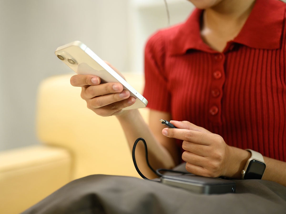 Person charging their cell phone with a power bank