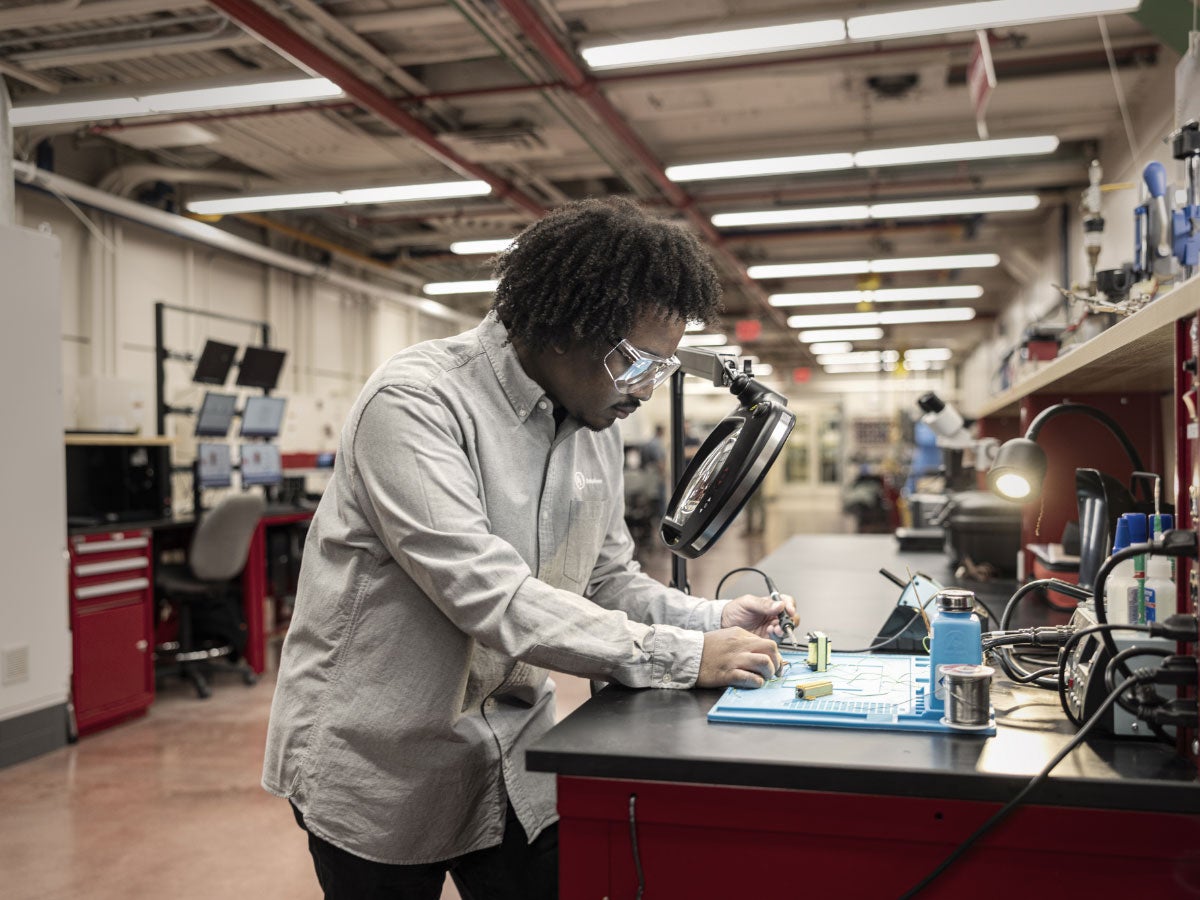 UL Solutions employee soldering at a workbench