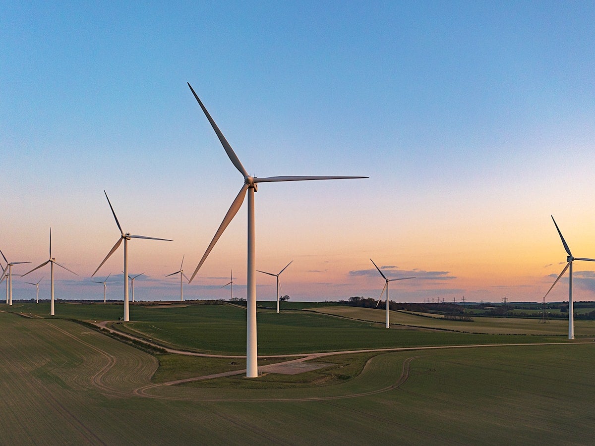 windmills in field at sunrise