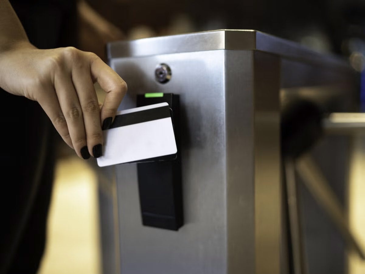 person swiping card to get through a turnstile