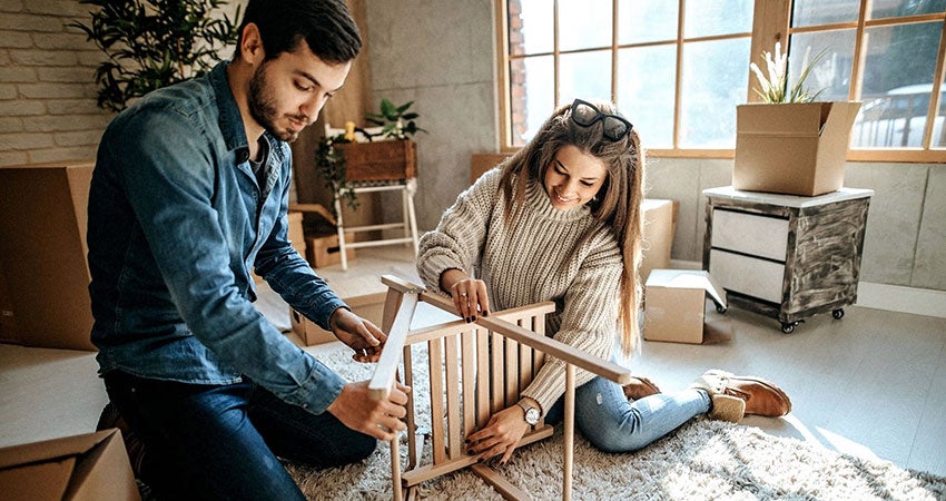 A couple putting assembling furniture