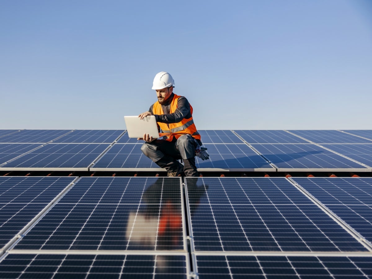 man on solar panels