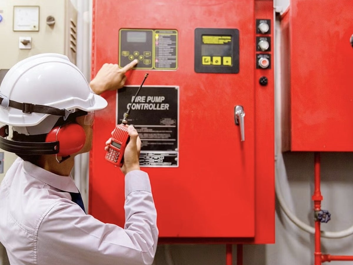 Worker pointing at a fire control pump