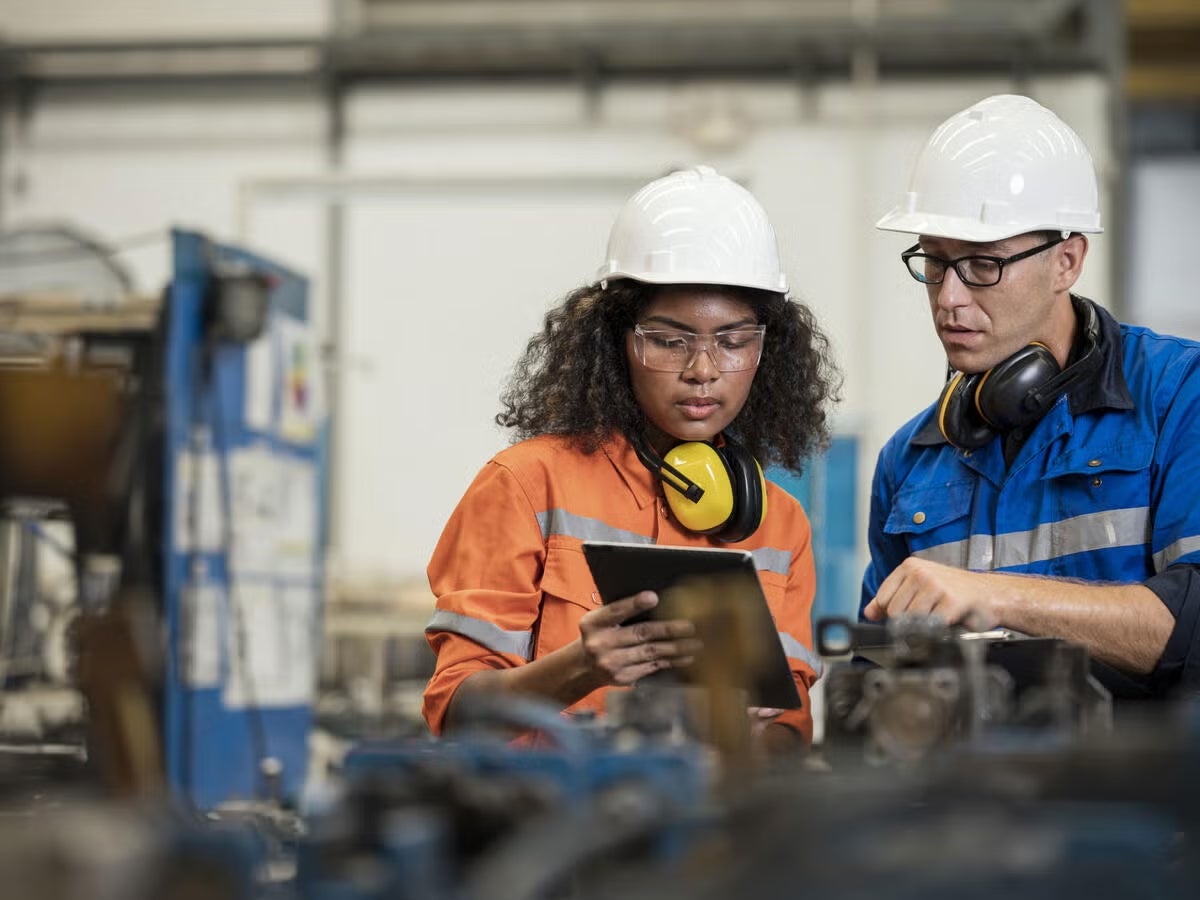 workers reviewing tablet