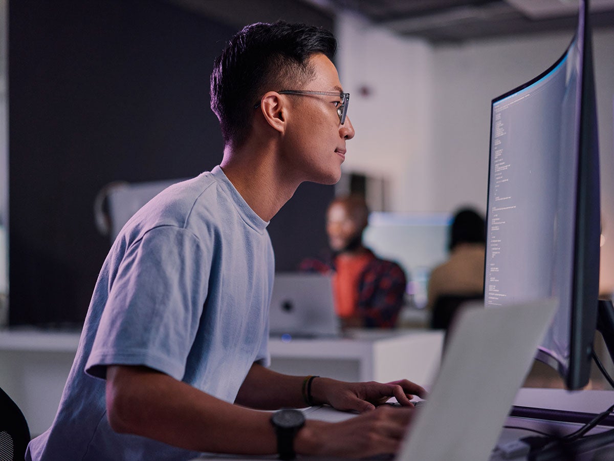 A person working and looking at a monitor