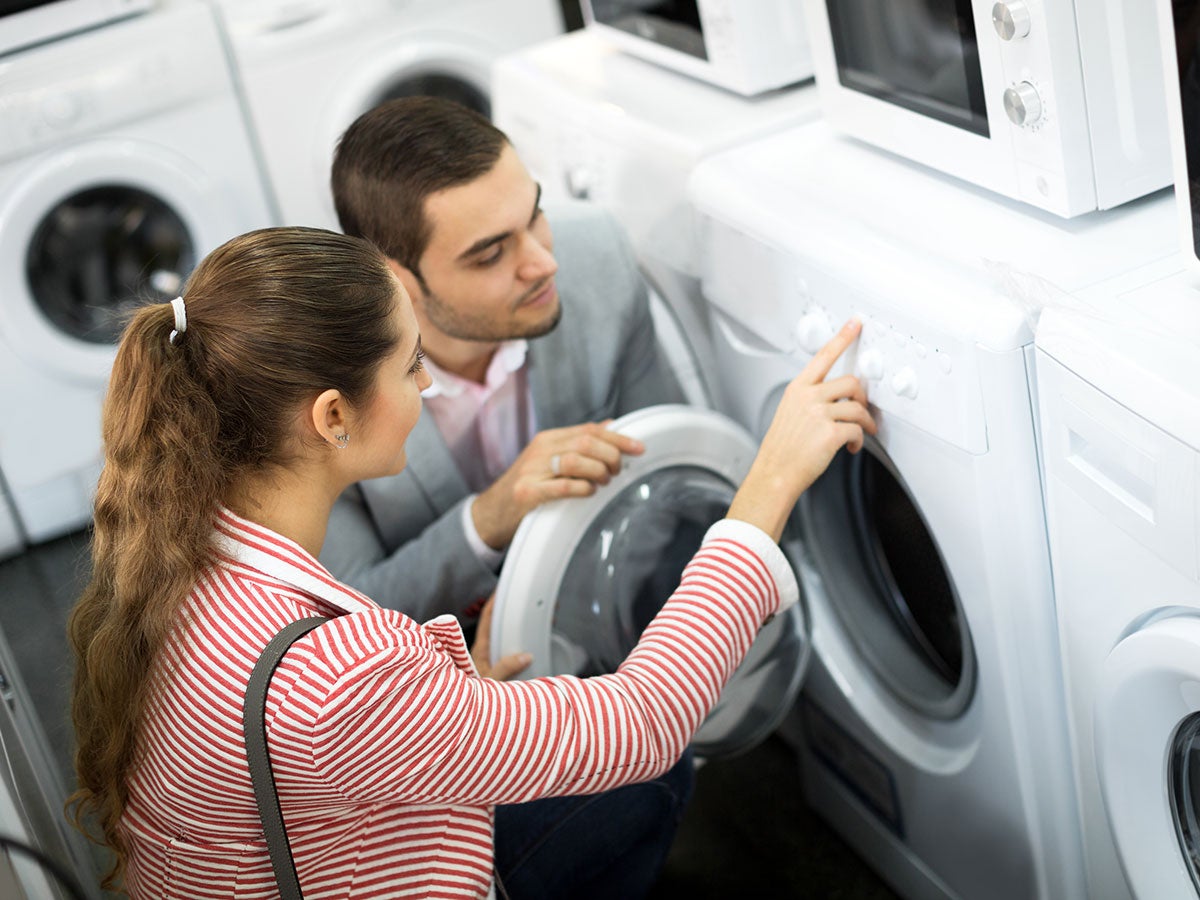 Two people inspecting a new dryer