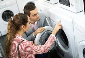 Two people looking at a dryer