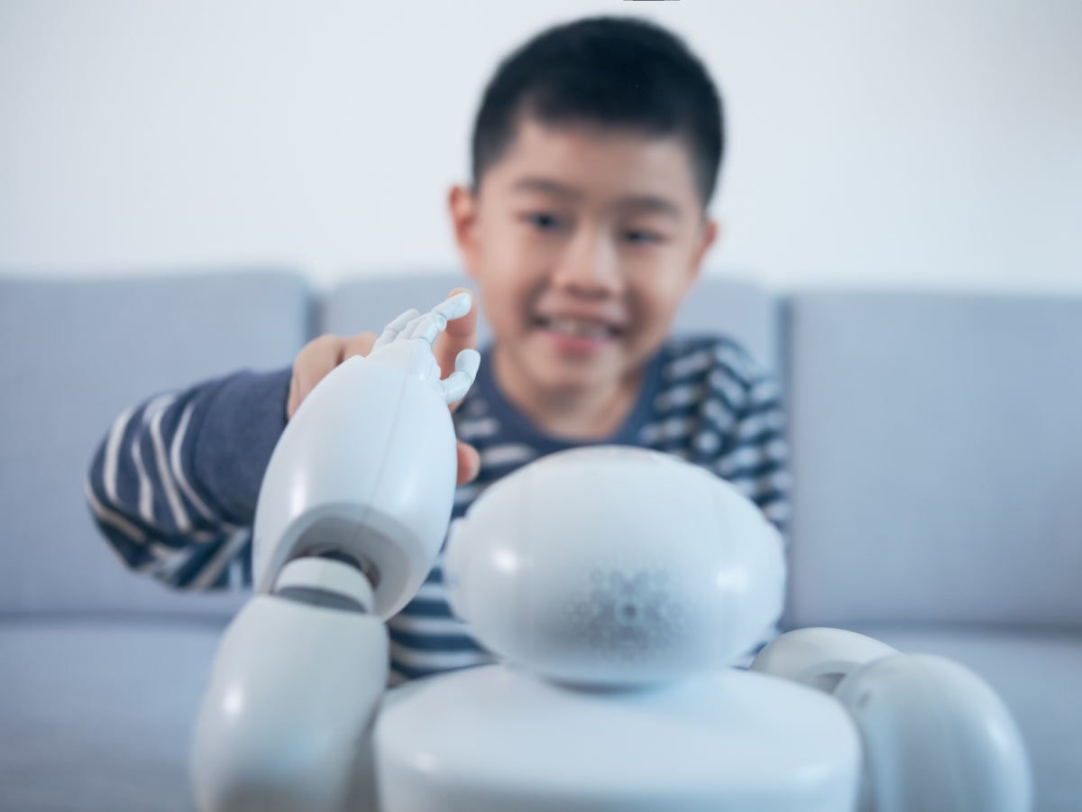 A child playing with a small robot